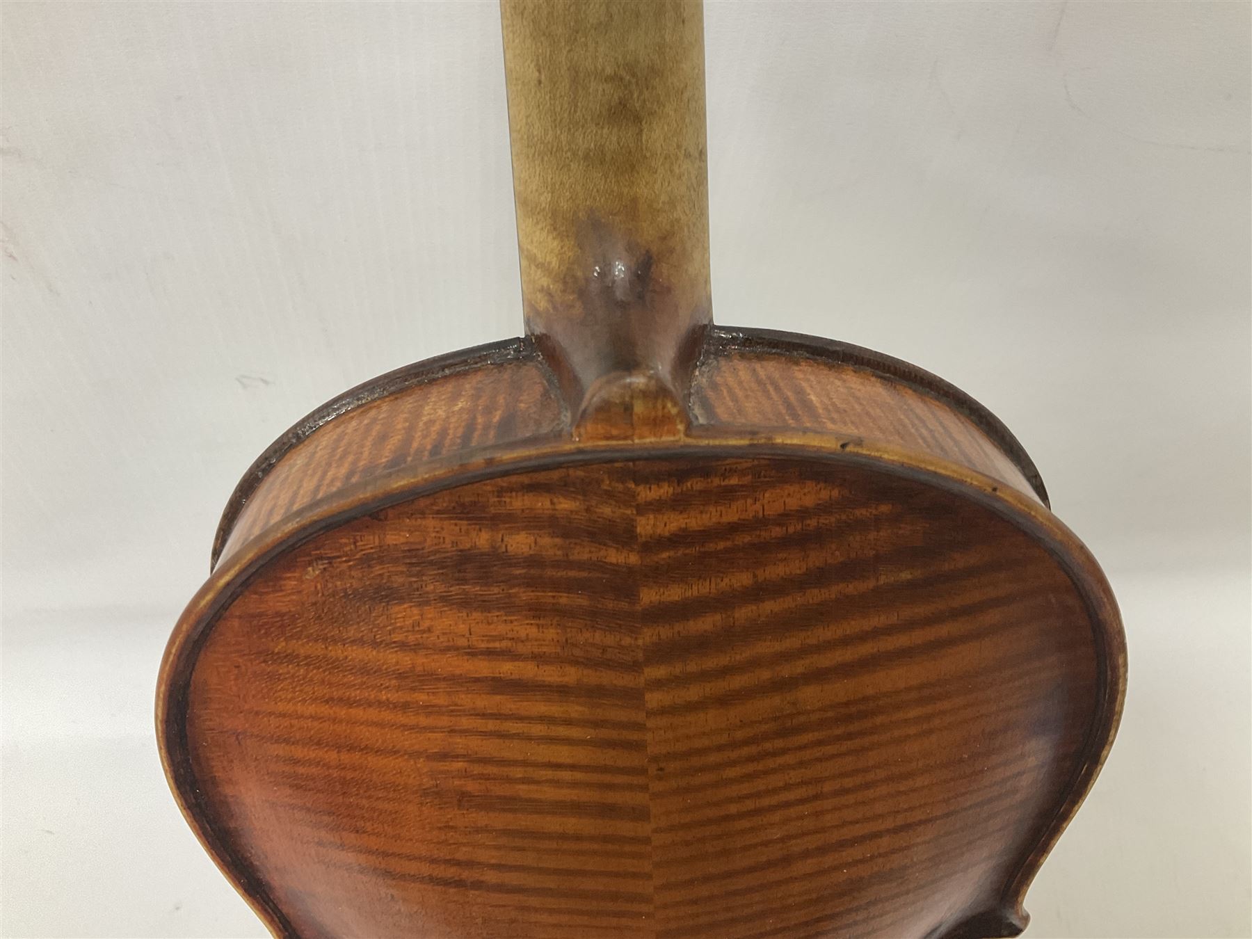 19th century full sized violin in a later hard case, decorative mother of pearl inlay to the tail piece Overall length 60cm No bow