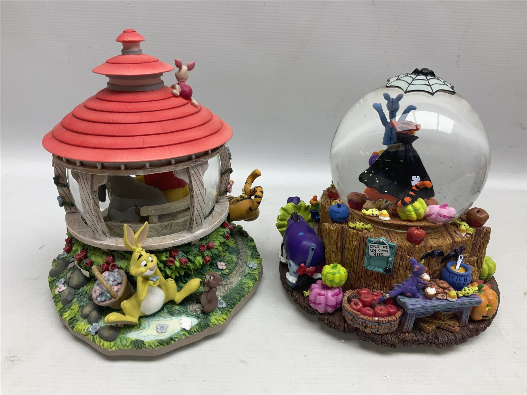 Six Disney Winnie The Pooh snow globes, to include four Halloween examples, including Tigger's Haunted House, together with Winnie The Pooh Gazebo snow globe and Bonfire snow globe, all with boxes