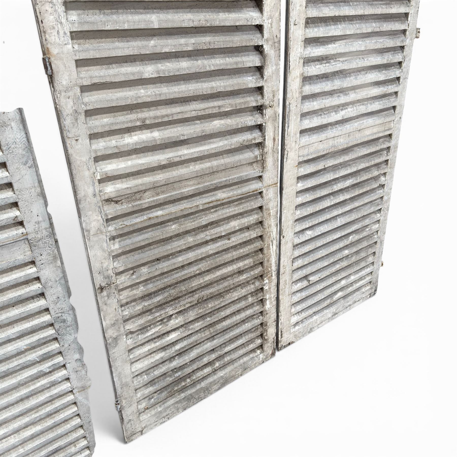 Five 19th century full height French Chateau louvre doors, pitch pine painted in cream finish, two having iron rod hinges, dimensions approx.