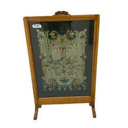 Edwardian inlaid mahogany elbow chair, shield back with pierced splat, serpentine seat, on square tapering supports with spade feet (a/f), and an oak framed fire screen with needle work panel (W48cm)