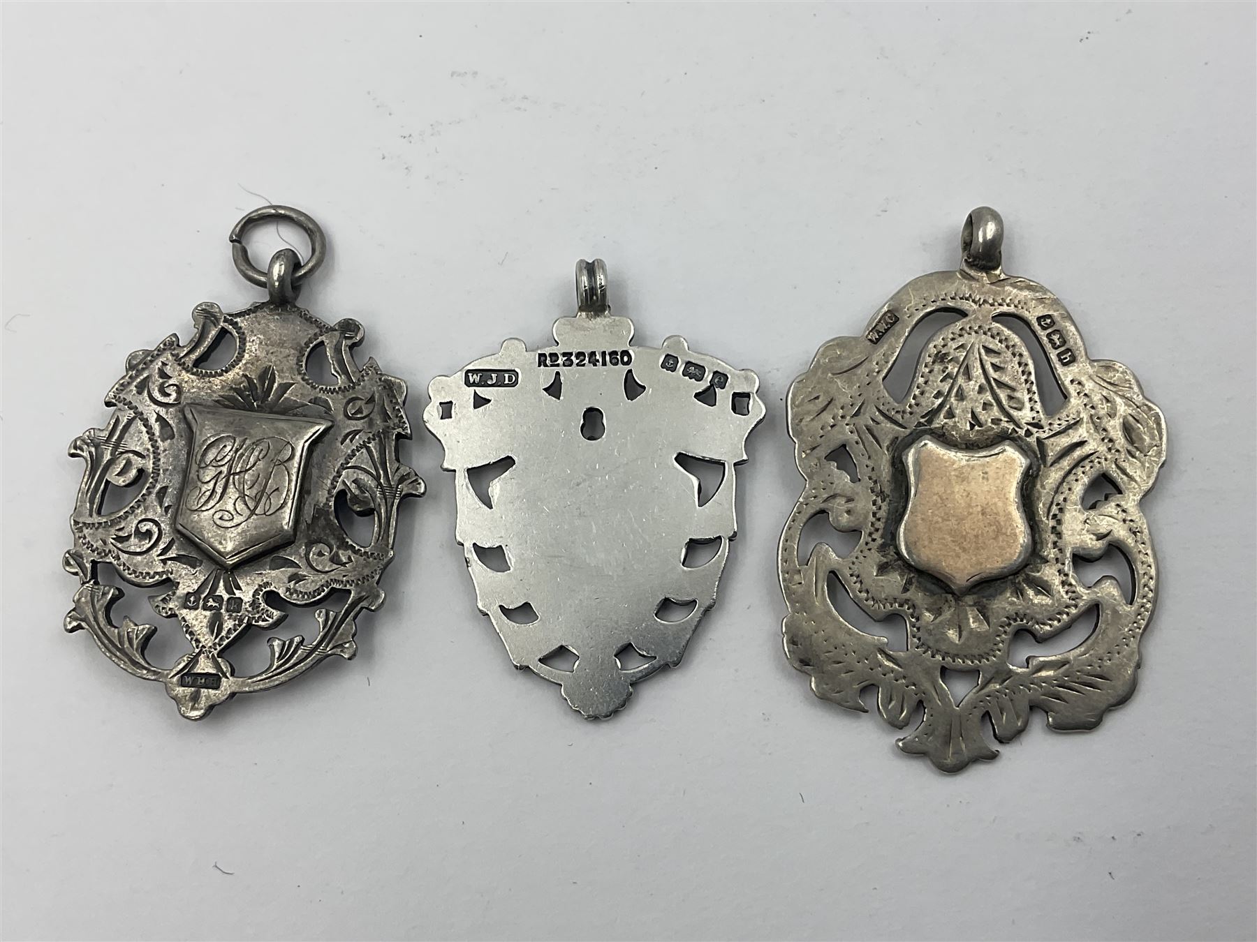 Seven Edwardian and later silver cartouche fobs, to include five gold faced examples and three double sided examples, all hallmarked with various dates and makers
