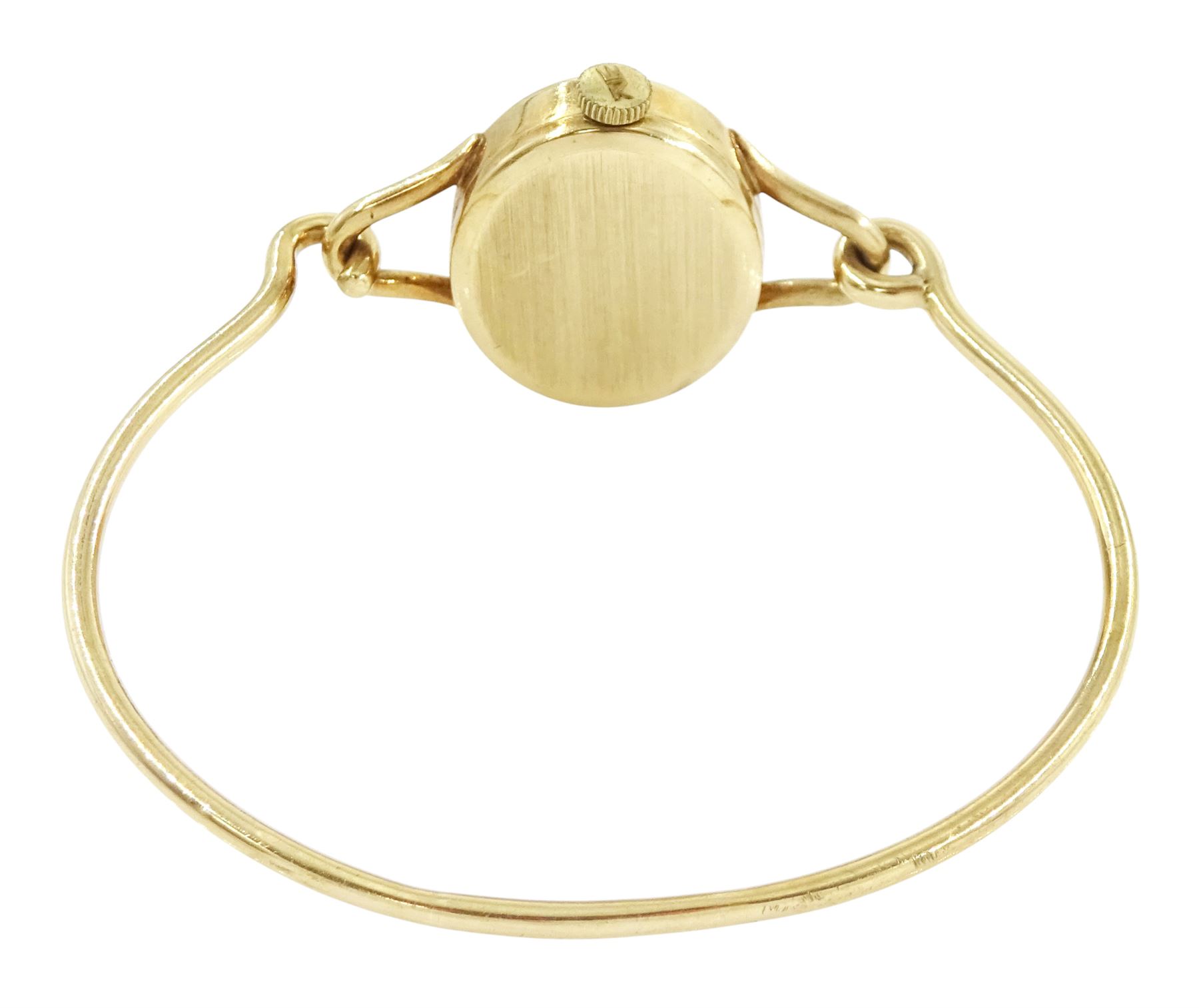 Roy King ladies 9ct gold manual wind wristwatch, black oval dial, on 9ct gold bangle, London 1978