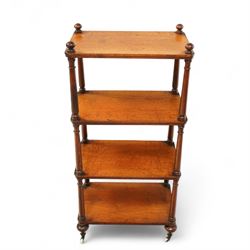 19th century mahogany four-tier whatnot, each rectangular shelf supported by turned uprights with ball finials, raised on turned feet with brass castors