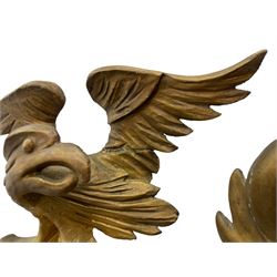 Pair of Regency period giltwood convex wall mirrors, moulded circular frame decorated with spherical mounts surmounted by a carved eagle with spread wings, foliage scroll carved upper and lower brackets, reed moulded and ebonised slip enclosed convex mirror plate 