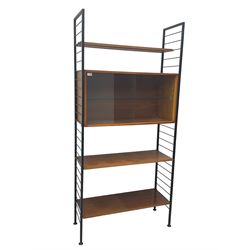 Staples Ladderax - mid-20th century teak and metal framed modular wall unit, fitted with central cupboard, the sliding glazed doors enclosing single shelf, flanked by three adjustable shelves 