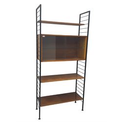 Staples Ladderax - mid-20th century teak and metal framed modular wall unit, fitted with central cupboard, the sliding glazed doors enclosing single shelf, flanked by three adjustable shelves 