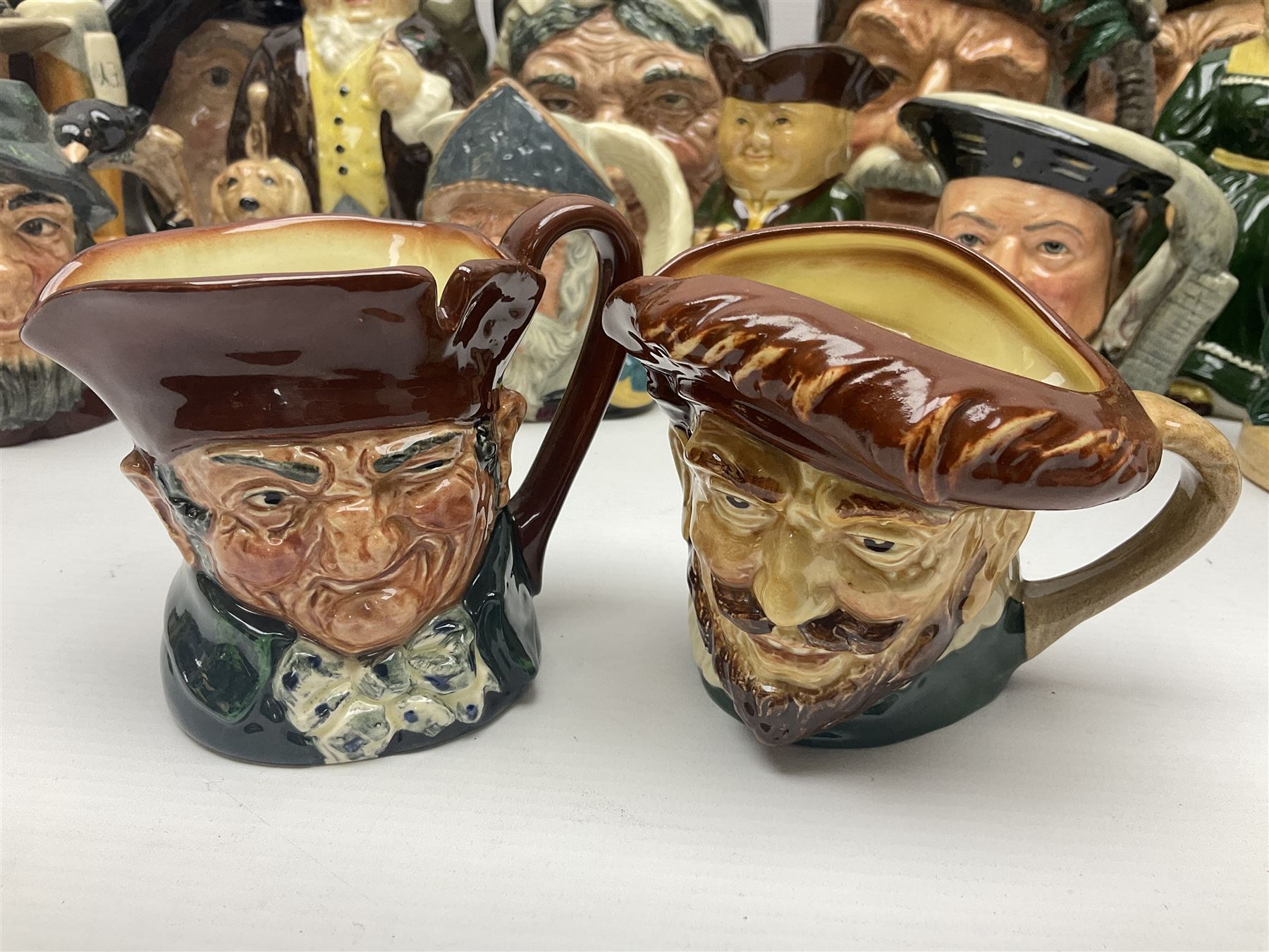 Large collection of Royal Doulton character jugs, to include Robinson Crusoe D6532, Tam O Shanter D6632, The Falconer D6533 etc, together with similar charater jugs and toby jugs   