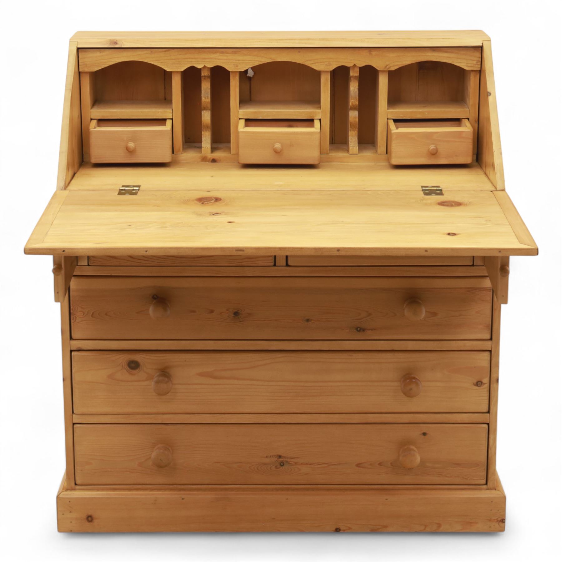 Contemporary waxed pine bureau, fall front enclosing fitted interior with pigeonholes and drawers, over two short and three long drawers with turned wooden knobs, on plinth base
