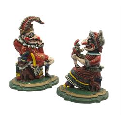 A pair of Victorian cast iron doorstops modelled as Punch and Judy, with painted polychrome decoration, largest H30cm. 