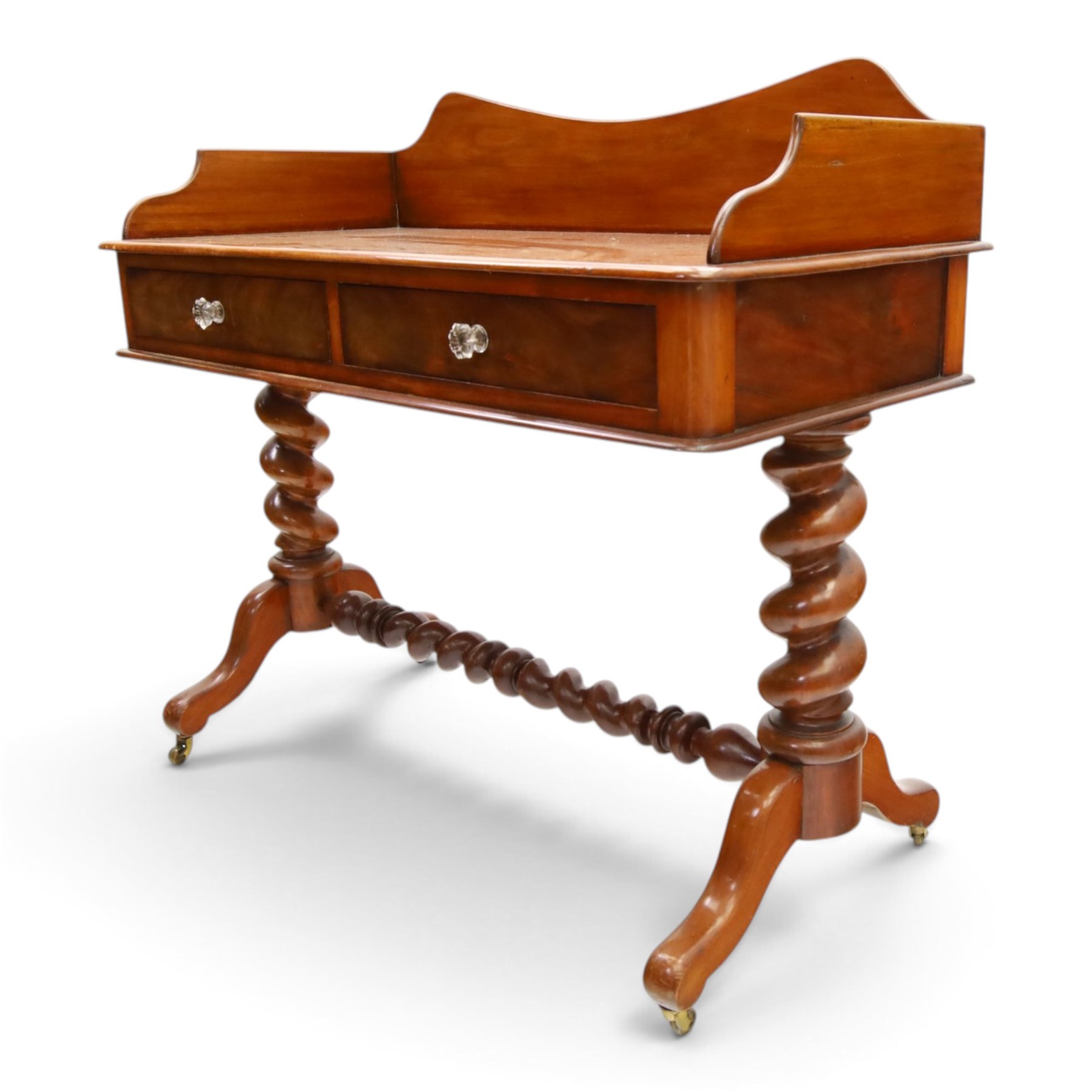 Victorian mahogany washstand with raised three-quarter back, fitted with two frieze drawers with glass handles, raised on spiral turned supports with splayed supports and castors united by barley-twist stretcher