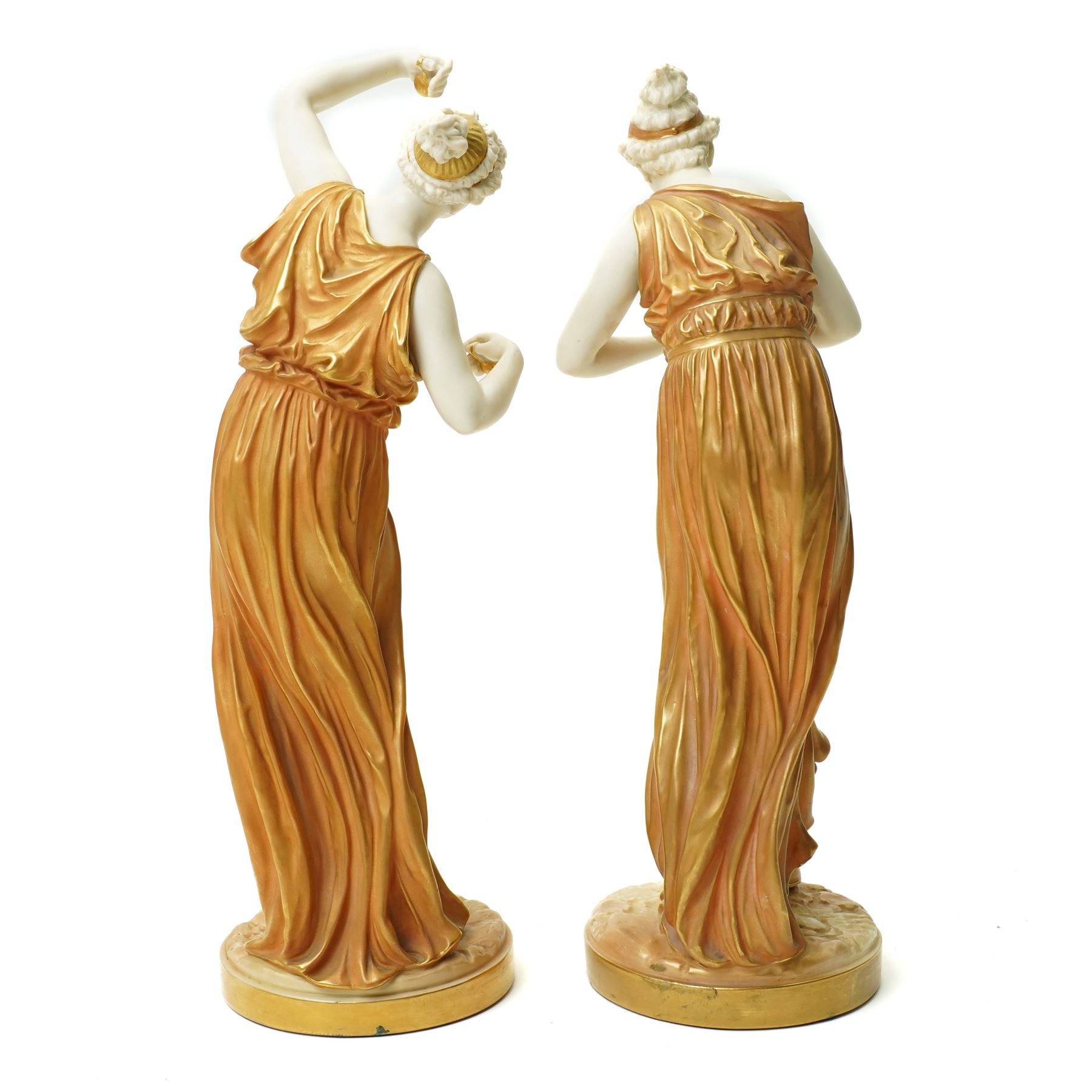 Pair of Royal Worcester figures of female musicians modelled by James Hadley, one with cymbals, decorated in gilt and on circular bases H33cm  