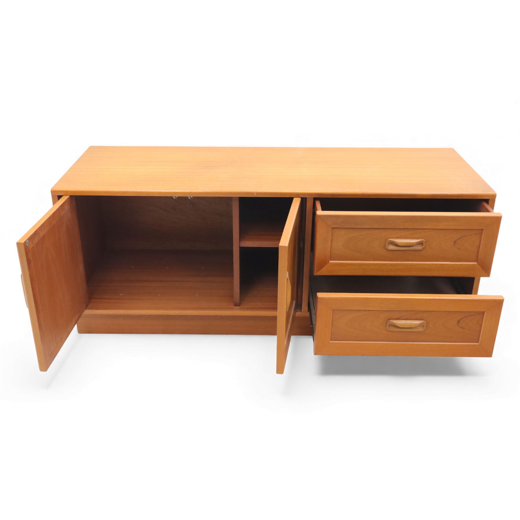 G Plan - 'Fresco' teak side unit, rectangular top above twin cupboard doors and two drawers, drawers fitted with cassette tape storage and a fall front drawer, raised on a plinth base