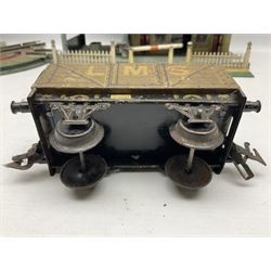 '0' gauge - Bing tin-plate two-storey double sided station with open walk-through to one end, rail side canopy, hinged doors and removable roof giving access to clock illumination L35cm; Bing hand-cranked turntable and open wagon; Marklin tin-plate level crossing barrier and Newspaper vendor's tin-plate four-wheel hand cart (5)