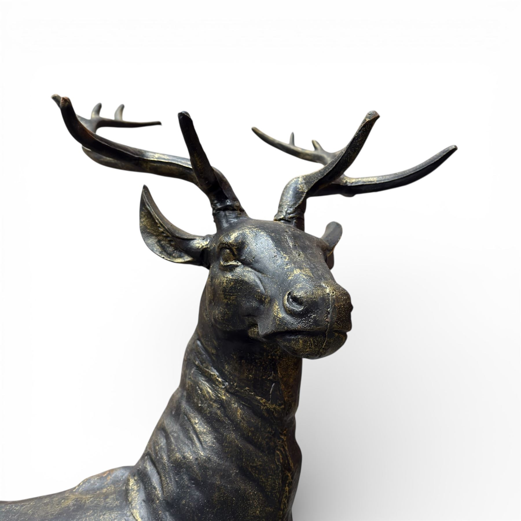Pair of life-size cast iron garden or home stags, modelled standing upon oval plinths