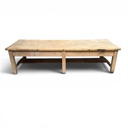 Large early/mid-20th century pine table or work bench, rectangular six plank top on eight tapering supports joined by slatted undertier