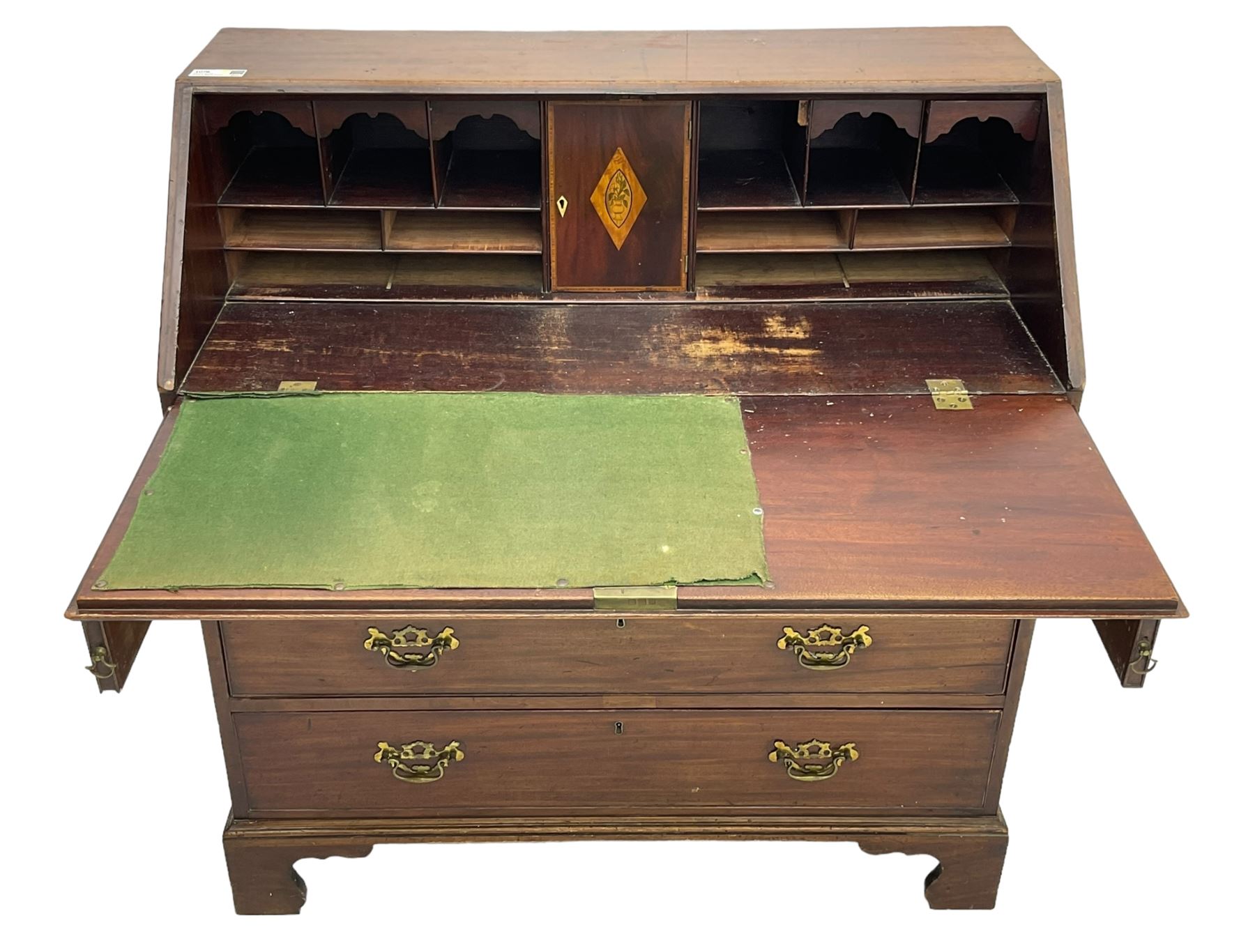George III mahogany bureau, the conch inlaid fall front enclosing pigeon holes, shelves and central cupboard with inlaid flower motif, four graduating cock-beaded drawers below each with brass handles, lower moulded edge over shaped bracket feet