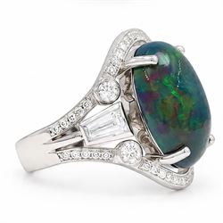 Platinum black opal and diamond ring, four claw set with a single oval cabochon opal of approx 8.45 carat, the openwork surround milgrain set with forty-eight round brilliant cut diamonds and tapered baguette cut shoulders, London 2025
