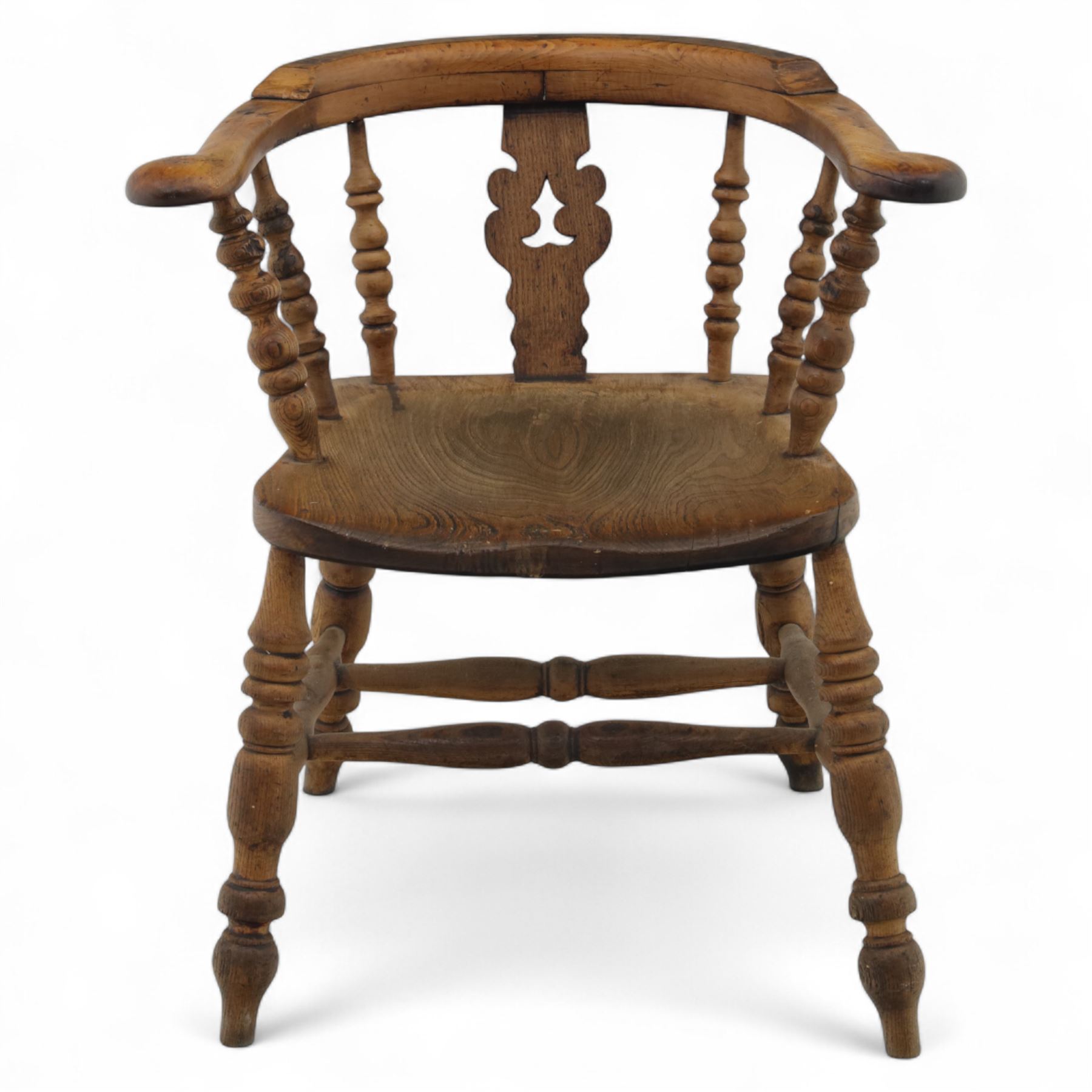 19th century ash and elm Windsor adapted armchair, continuous curved arm with turned spindle supports and shaped splat, saddle seat on turned legs united by crinoline stretcher
