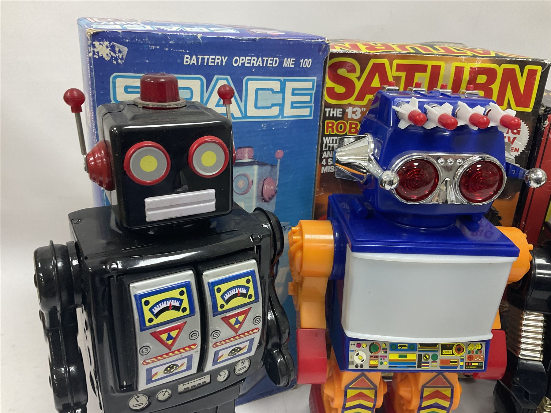 Three vintage battery operated robots comprising tin-plate Space Walk Man ME 100 Robot, Saturn the 13