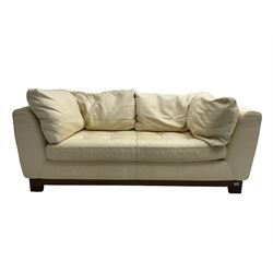 Roche-Bobois - two seat sofa, upholstered in ivory leather with buttoned seat cushions, raised on a stained beech base with bracket feet