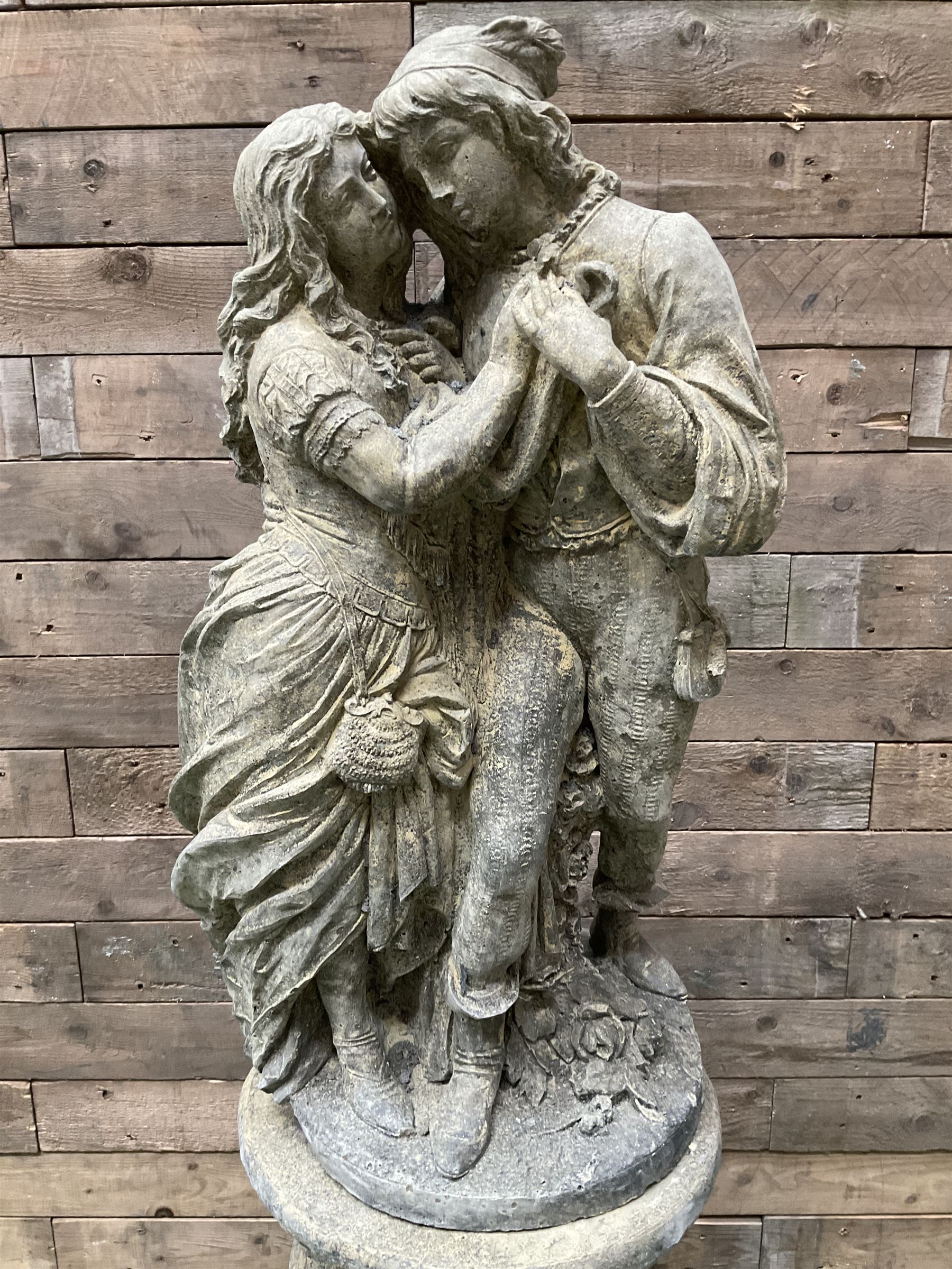 Romeo & Juliet - cast stone garden figure raised on circular fluted column - THIS LOT IS TO BE COLLECTED BY APPOINTMENT FROM DUGGLEBY STORAGE, GREAT HILL, EASTFIELD, SCARBOROUGH, YO11 3TX