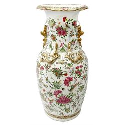 Late 19th century Chinese Rose Canton vase, with lobed rim and applied twin gilt temple lions to the waisted neck, and four gilt dragons to shoulders, hand painted with exotic birds, butterflies and blossoming flowers, H43.5cm