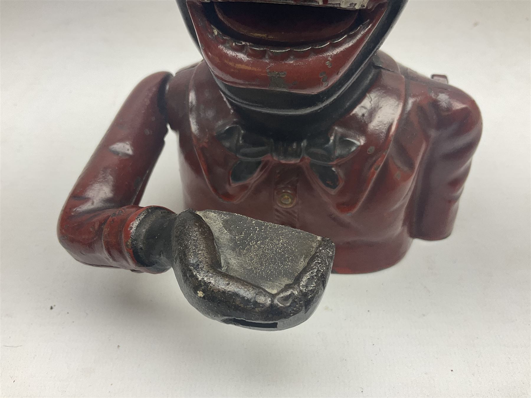 Three early 20th century cast-iron mechanical money banks as a family group comprising mother 'Dinah' patented 1911, father 'Jolly Man' patented 1902 and son 'Little Joe' patented 1910 by John Harper & Co; all with the same hand-to-mouth action; parents H16cm (3)