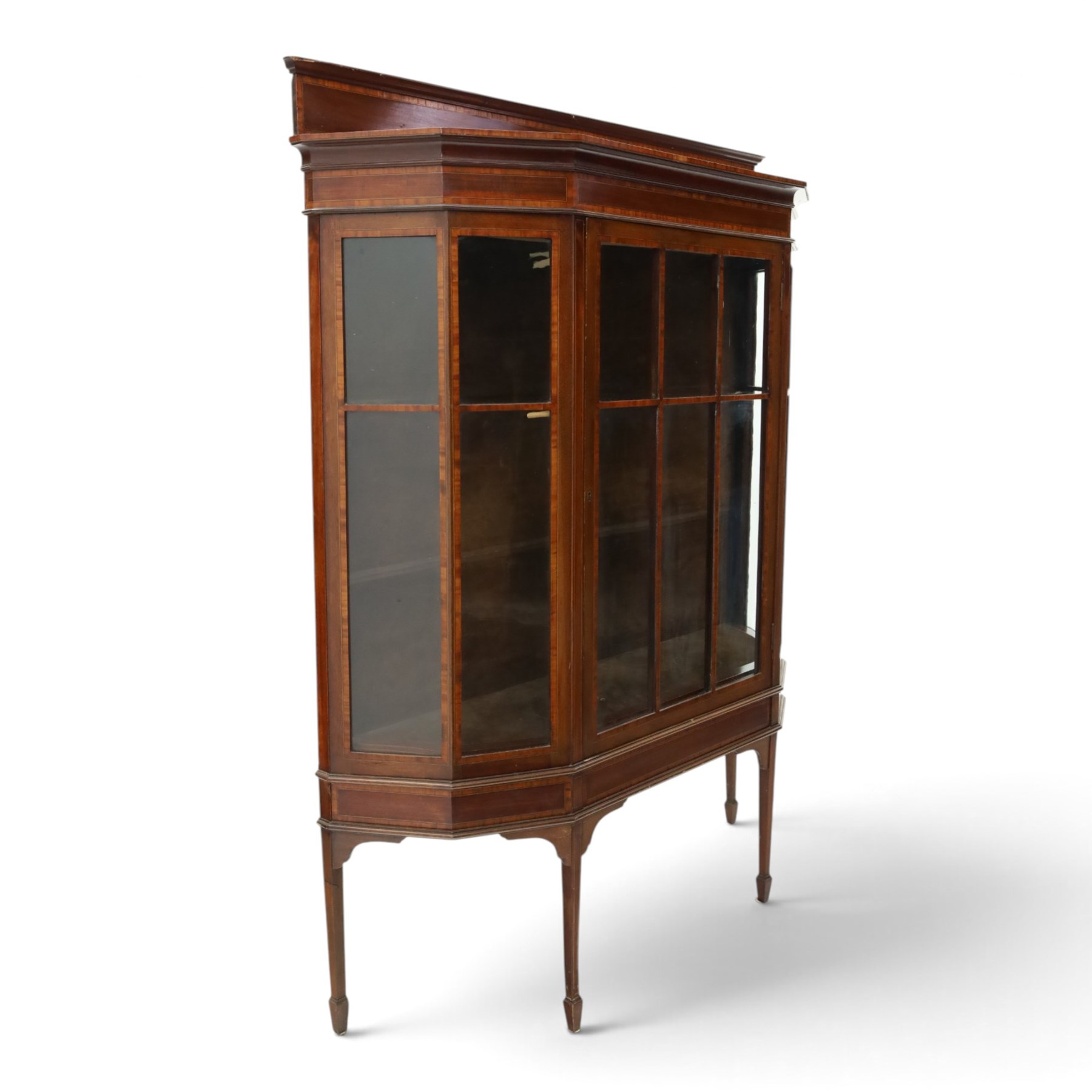 Edwardian inlaid mahogany display cabinet of rectangular canted form, galleried top with crossbanded inlay, above a glazed cabinet enclosing  baize lined shelves, raised on square tapering legs terminating in spade feet  