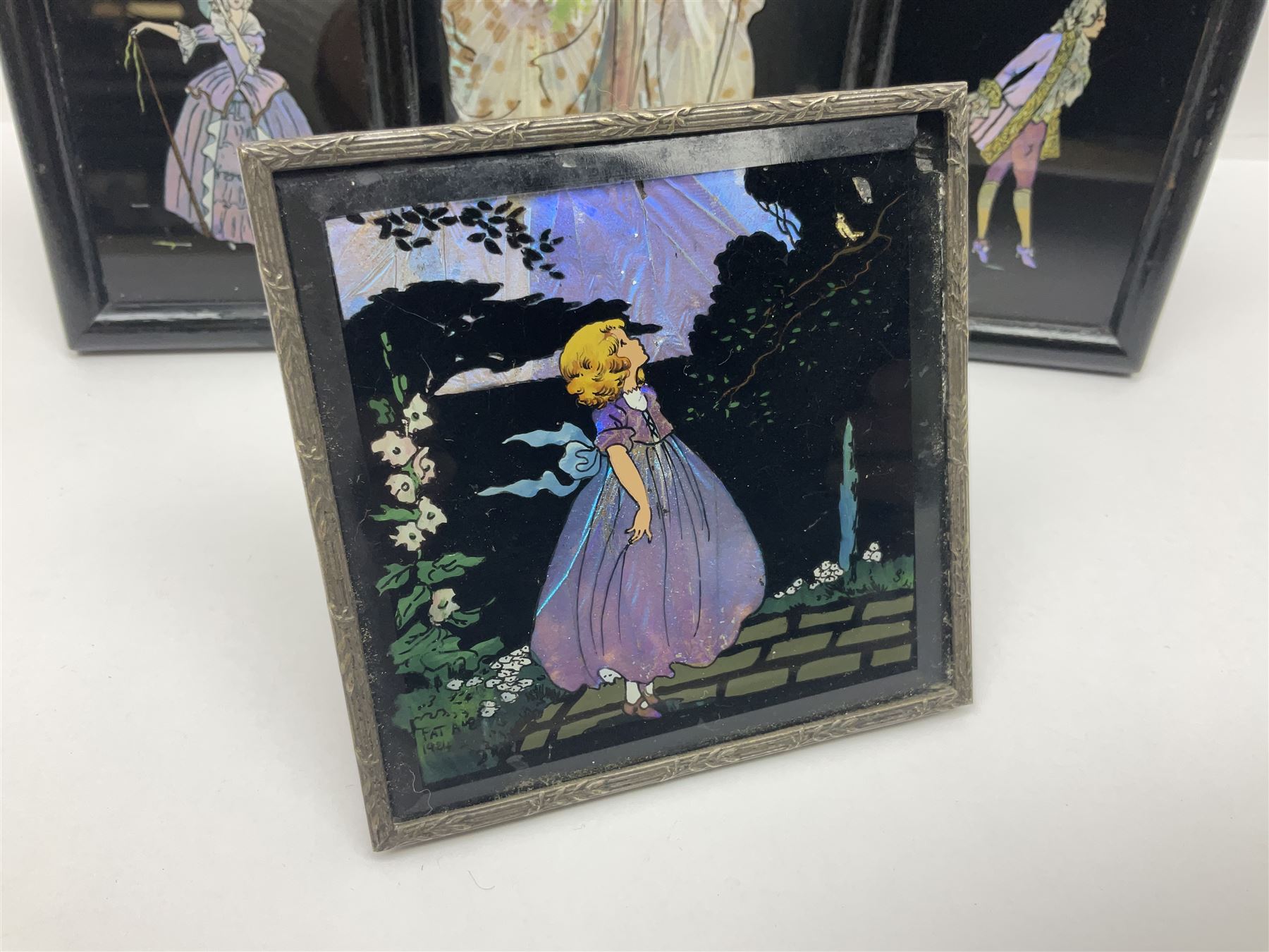 Seven 1930's butterfly wing pictures, mainly of ladies in period dress, one signed Dorothy Buckley, largest H18cm