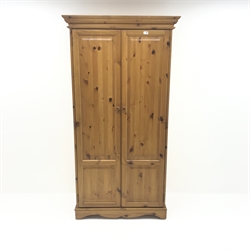 Solid pine double wardrobe, projecting cornice, two doors enclosing fitted interior, shaped plinth base, W99cm, H191cm, D60cm