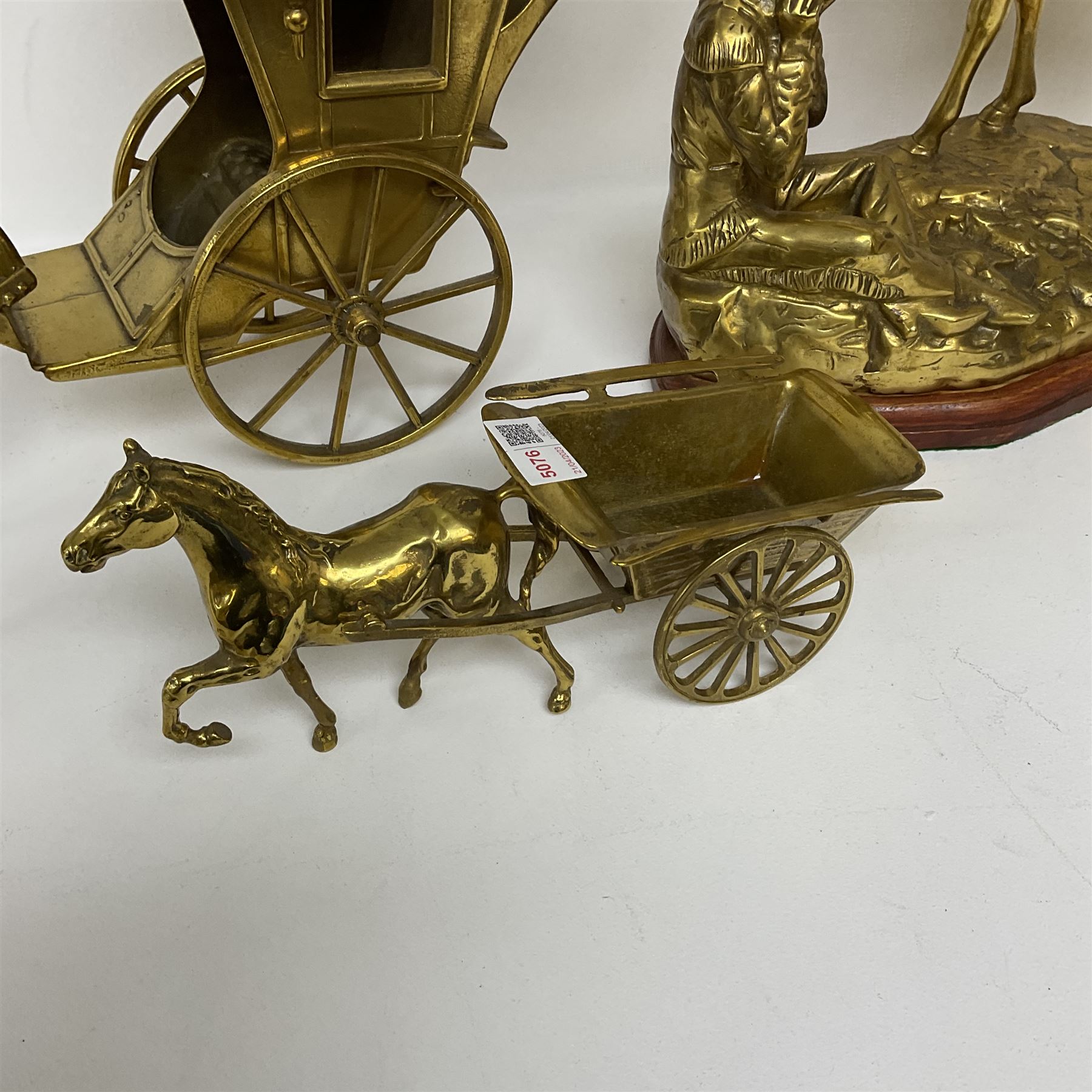 Three brass figures, one depicting a cowboy and his horse, two of horses and carts, largest H30cm