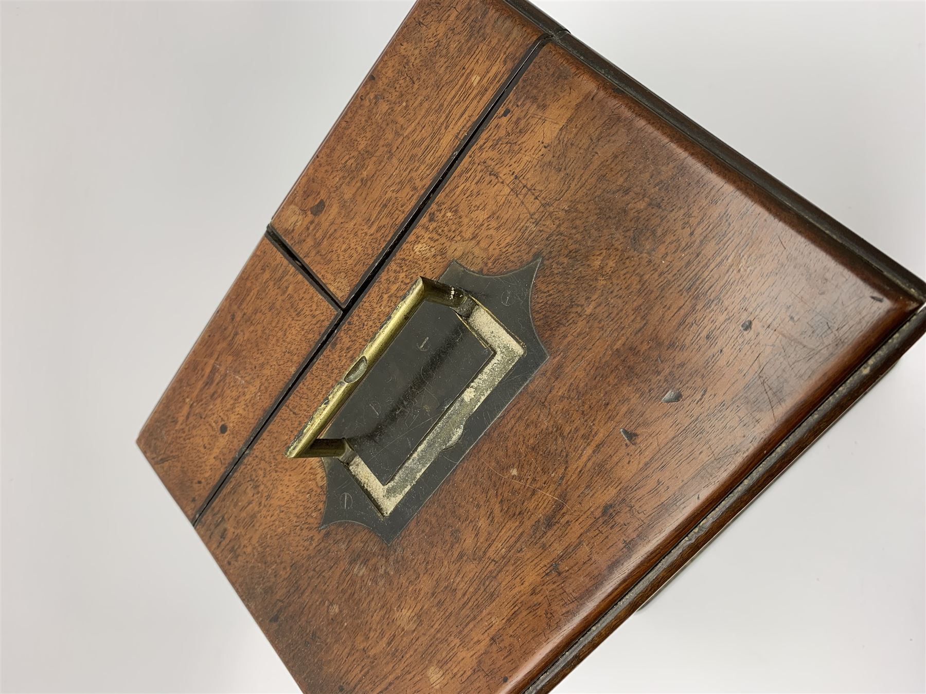 19th century mahogany travelling apothecary cabinet, with recessed brass carry handle to top, and two deep-section hinged doors to the front opening to reveal a fitted interior with clear glass bottles and two drawers, H27cm