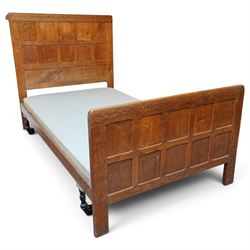 Mouseman - pair of 1930's adzed and panelled oak single beds, the head and foot-boards with arcade-carved cresting rails above adzed panels, with Vibase mattress supports, carved with mouse signature, by the workshop of Robert Thompson of Kilburn