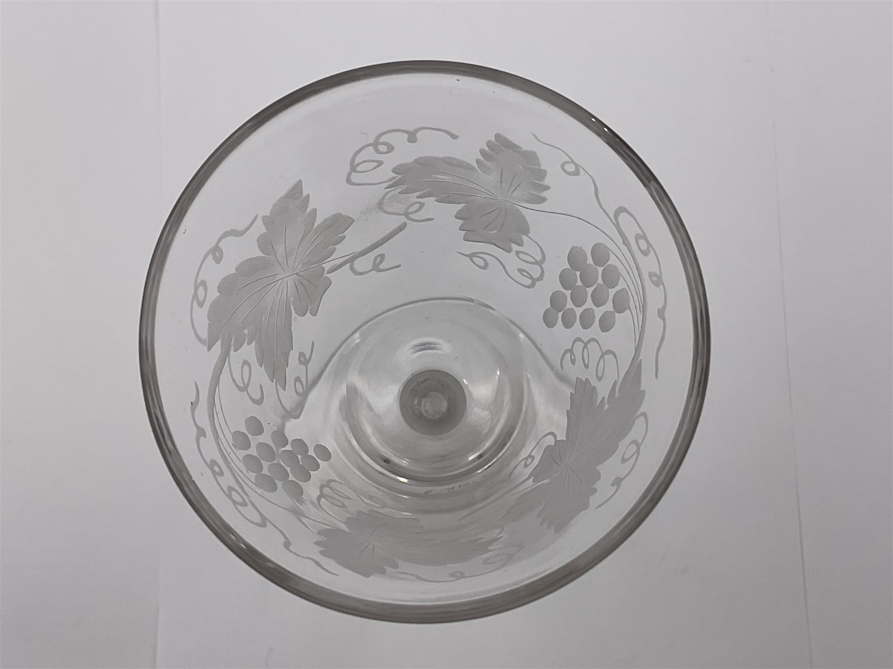 Set of three 18th century style wine glasses, each with funnel bowl etched with fruit vine, upon a double series air twist stem and circular foot, H17cm