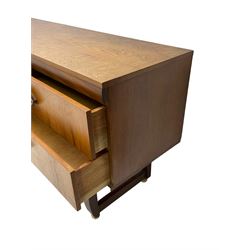 Mid-20th century circa. 1970s teak sideboard, rectangular top over four drawers with pointed elliptical handles, straight block supports joined by stretchers on castors