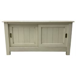 Cream finish low side cabinet, moulded rectangular top over two sliding panelled doors, on stile supports 