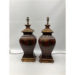 Pair Oriental table lamps decorated with birds in a tree with fruit, on a red ground with a gilded base together with cream lampshades H57cm, without lampshade. 