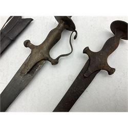 Late 19th/early 20th century Indian Tulwar sword with 81cm plain curving steel blade and iron hilt with extended langets, knucklebow and spiked pommel; in leather covered scabbard L100cm overall; and another Tulwar lacking scabbard in almost relic condition (2)