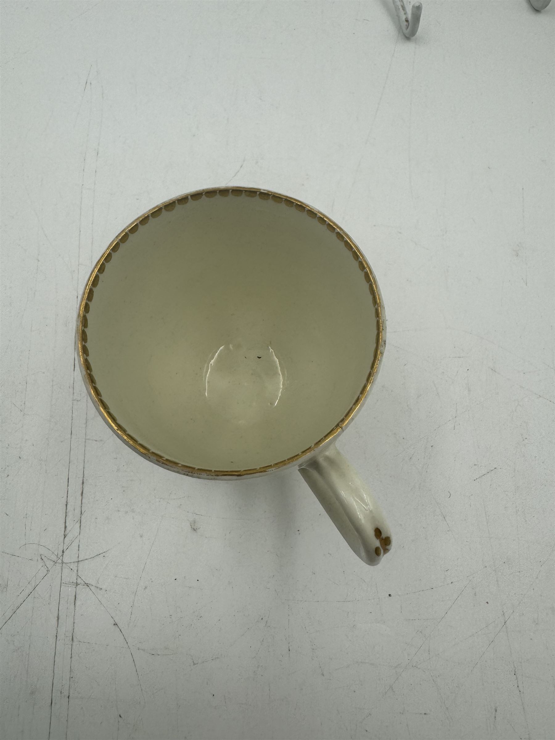 18th century Caughley blue and white sparrow jug, decorated in the Mother and Child pattern, circa 1780-1790, with underglaze C mark beneath, H9cm, together with a Worcester coffee cup, circa 1785 painted with floral sprays in underglaze blue and gilt, with crescent mark beneath, and a Caughley trio of tea cup, tea bowl and saucer, each of moulded wrythen fluted form and decorated with gilt and blue sprigs and bands, each with crescent mark beneath, (5)