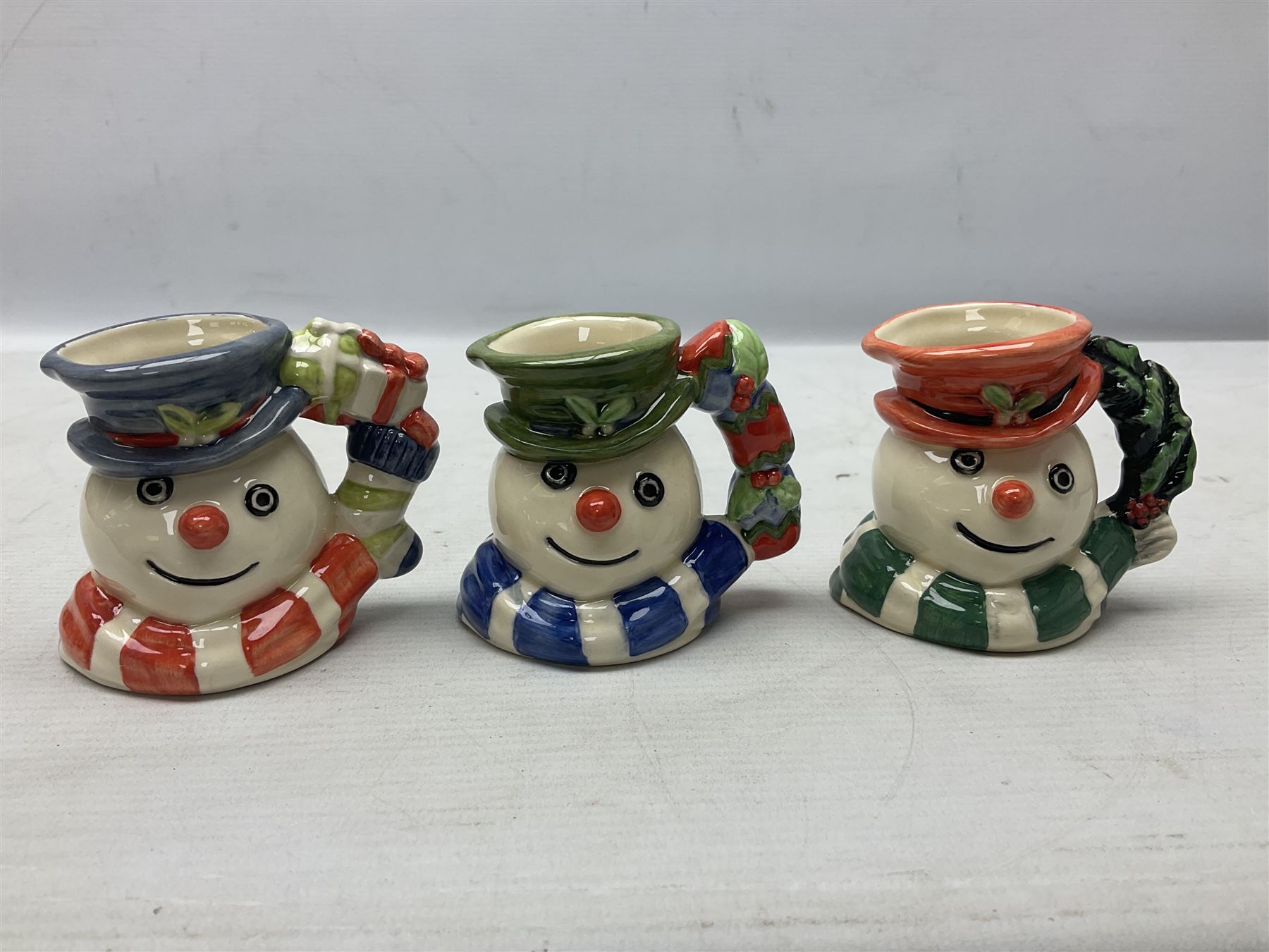 Three Royal Doulton The Mickey Mouse Collection figurines comprising Mickey Mouse MM1, Minnie Mouse MM2, and Goofy MM5, together withe three Royal Doulton limited edition miniature snowman character jugs comprising Christmas Stocking Snowman D7124, Christmas Cracker Snowman D7158 and Snowman D7062, all with original boxes 