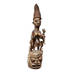 African tribal maternity figure of a woman with children, probably Yoruba, carved wood, th...