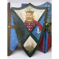 Four decorative painted wooden wall mounting shields, H91cm