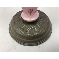 Pink opaline glass oil lamp of baluster form made with hand painted floral decoration upon a circular plinth, H80cm