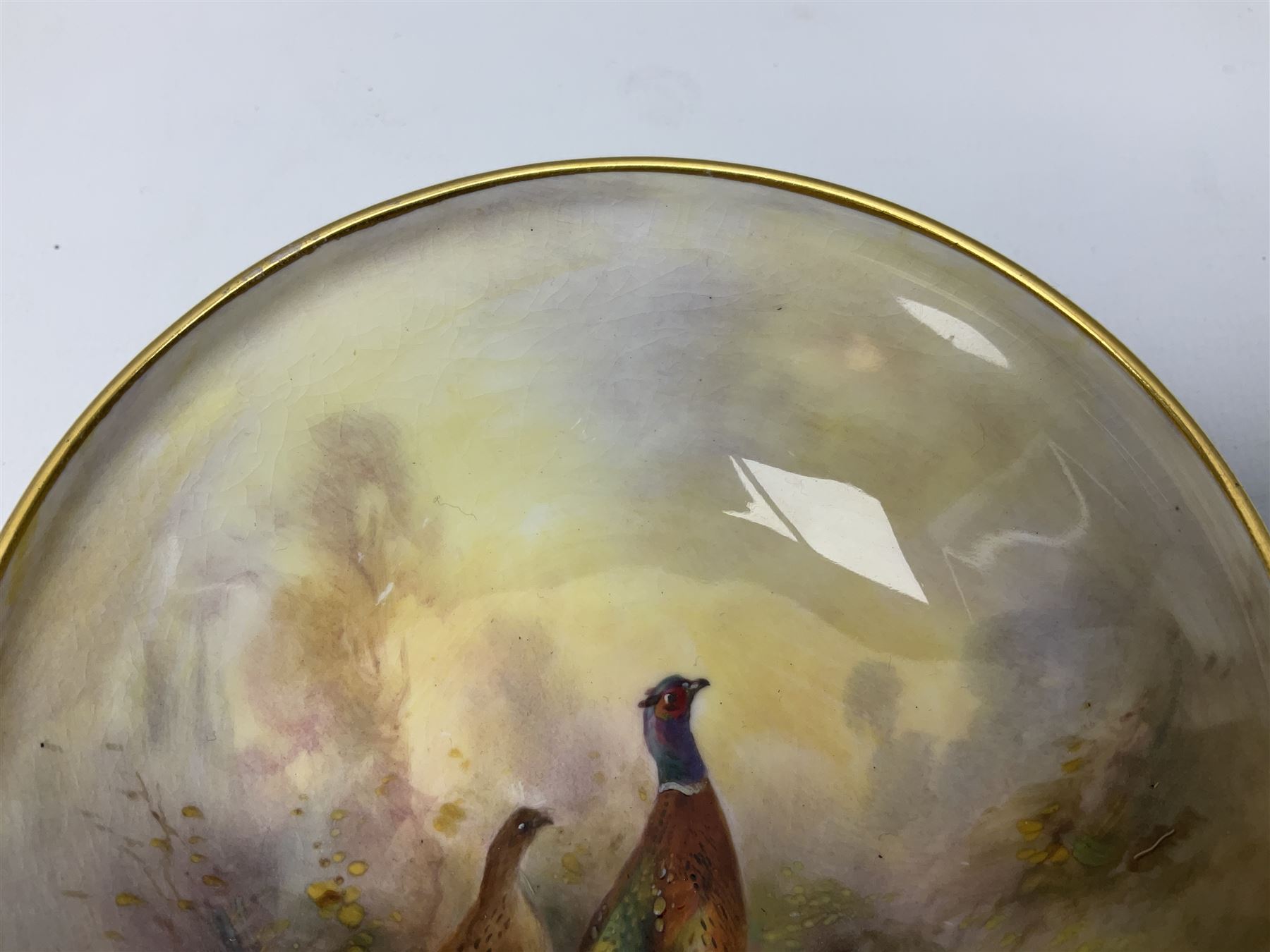 1938 Royal Worcester circular pedestal pin dish, decorated with pheasants in a landscape by James Stinton, with printed mark beneath, D10.5cm