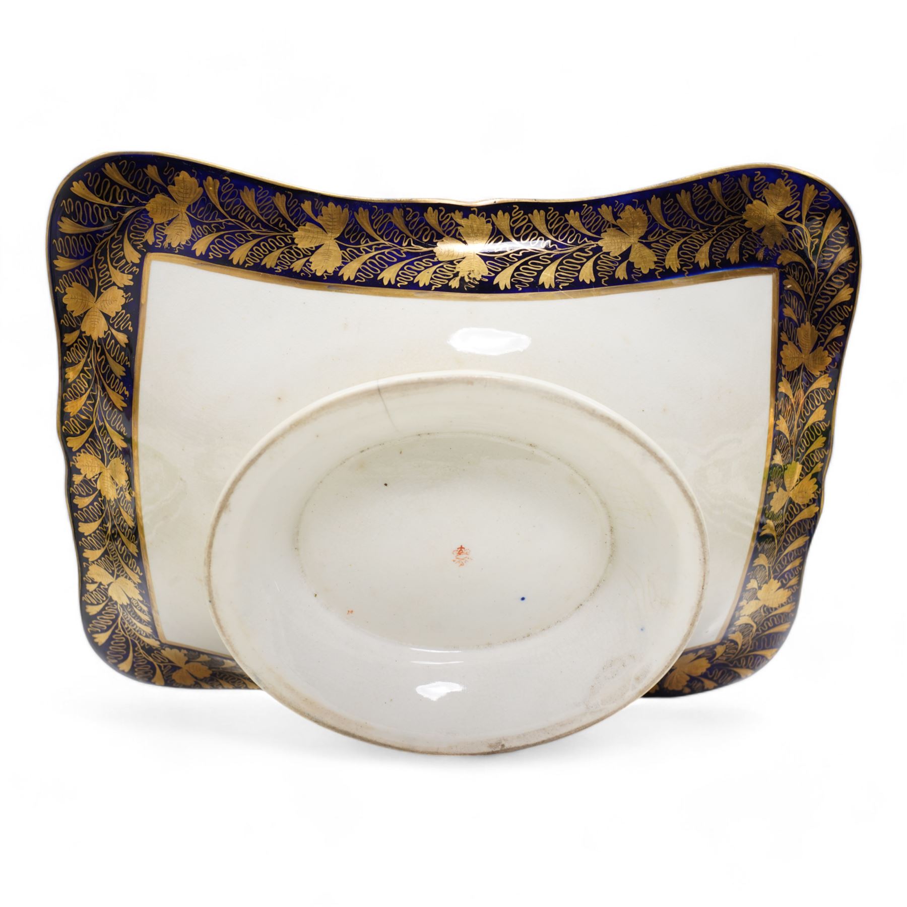 Large early 19th century Derby porcelain dessert basket, of rectangular twin-handled form, with cobalt blue and gilt decoration, painted marks beneath, L29cm together with a 19th century porcelain dessert service, decorated with floral sprays within a green and gilt border, comprising eight plates and three serving dishes, pattern no. 701/1