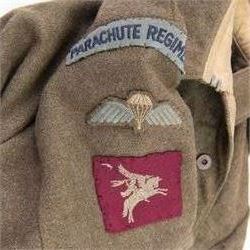 WWII British parachute regiment battle dress uniform, the jacket with shoulder title and Pegasus formation badge to the left arm, shoulder title, Pegasus formation badge and cloth wings to the right, size 3 dated 1943, the trousers size 3 dated 1945 