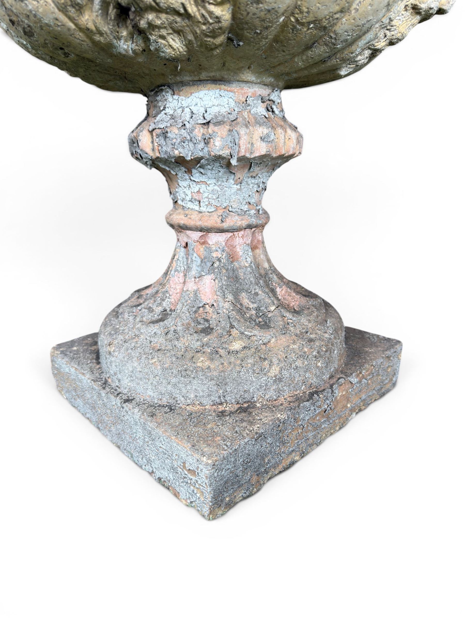 19th century terracotta campana shape urn planter, egg-and-dart moulded rim over a cherub-mask and gadrooned underbelly, turned pedestal and socle on square base