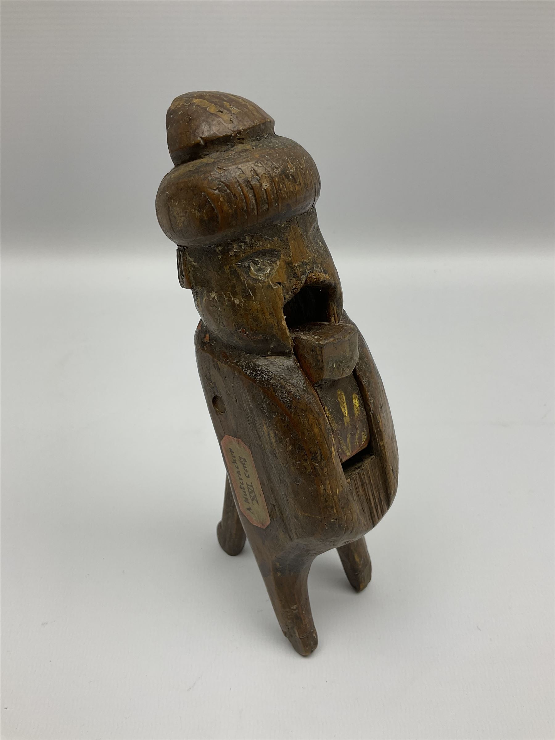 Rare primitive treen lever action nutcracker, probably late 17th/early 18th century, carved in the form of a man, with old collector label to side inscribed 'A Nutcracker XVI Century', H18cm