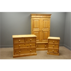  Pine double wardrobe enclosed by twp panelled doors, (W91cm, H165cm, D61cm), pine chest two short and three long drawers and matching bedside cabinet with three drawers.  