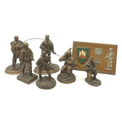 Six Phoenix World Reproductions bronzed figures of soldiers including Special Operations, Law firer, Jungle, radio carrier, Airborne etc, tallest H24cm; and oak Regimental plaque for 1st Bn The Devonshire and Dorset Regiment with strut support (7)